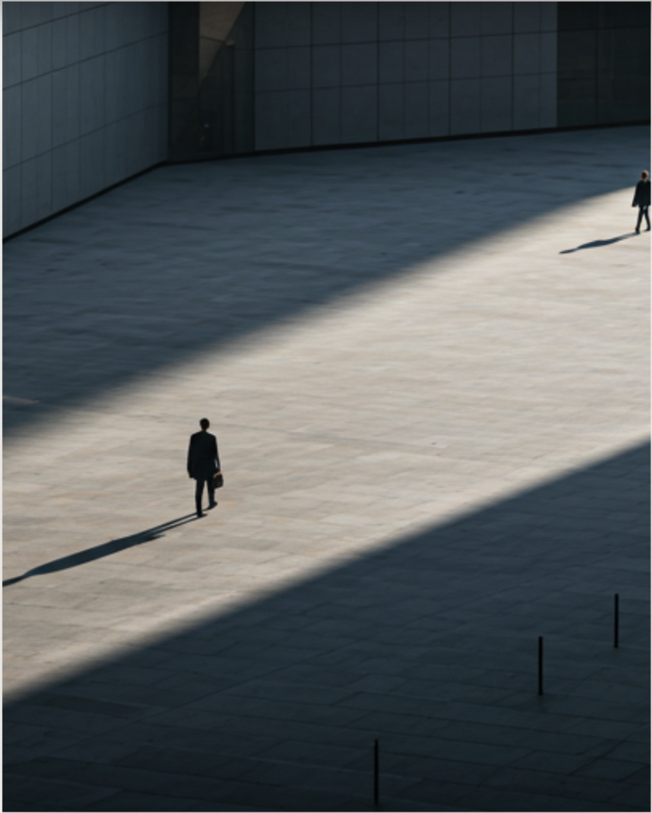 A lone figure crossing a sunlit plaza, evoking the considered, long-term path ETY Capital Partners takes with founders.